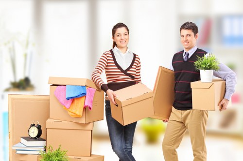 A local moving team unpacking boxes room by room in a Hampton Hill property