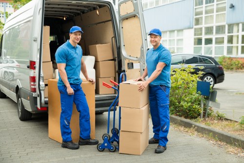 Moving team unloading boxes at a Hampton Hill property