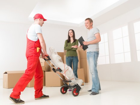 Furniture being carried from an upper-floor flat in Hampton Hill